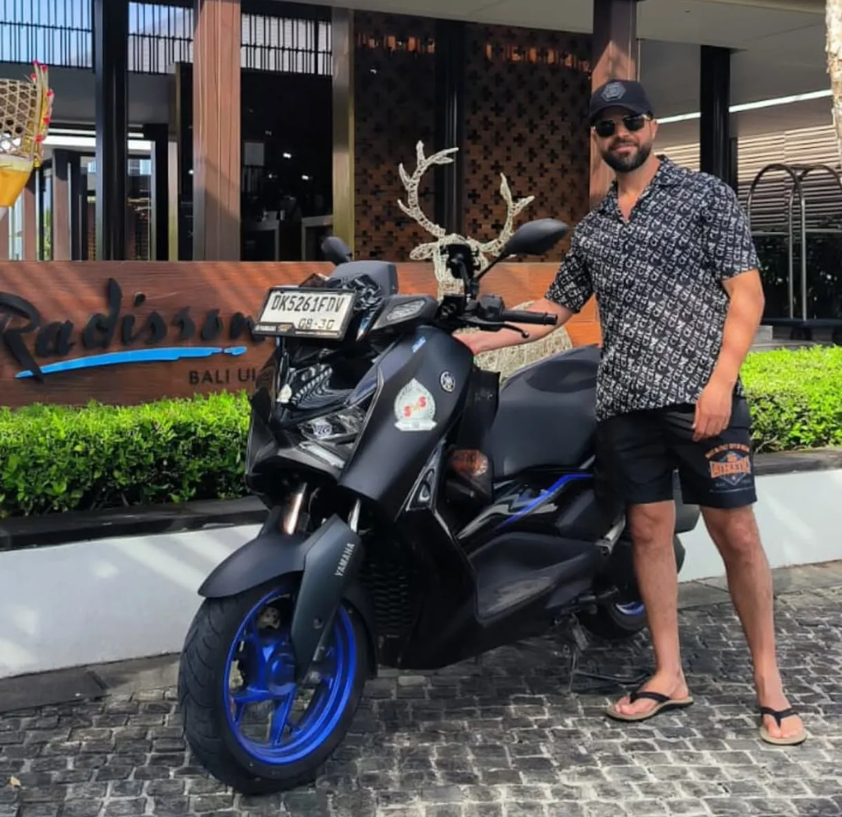 Customer in front of the SMS Rental Bali shop